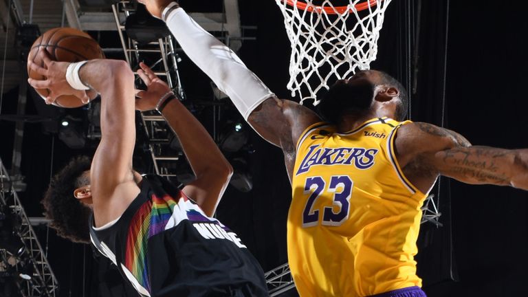LeBron James soars to meet Jamal Murray at the rim during the Los Angeles Lakers' Game 4 win over the Denver Nuggets
