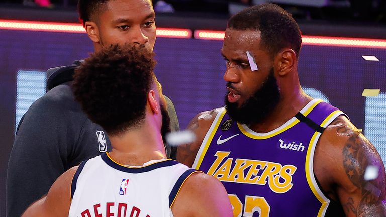 LeBron James embraces Denver guard Jamal Murray after the Lakers eliminated the Nuggets in the Western Conference Finals