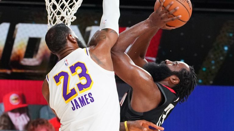 LeBron James rises to deny James Harden at the rim