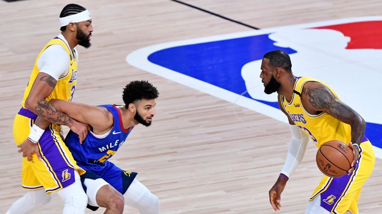 LeBron James of the Los Angeles Lakers handles the ball against Jamal Murray of the Denver Nuggets during Game One of the Western Conference Finals