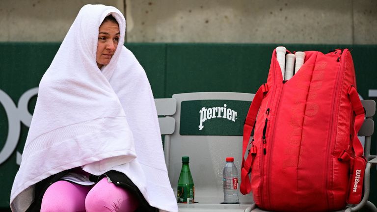 Russia's Margarita Gasparyan covers herself with a towel while it rains during her women's singles first round tennis match against Belgium's Elise Mertens at the Simonne Mathieu court on Day 1 of The Roland Garros 2020 French Open tennis tournament in Paris on September 27, 2020.