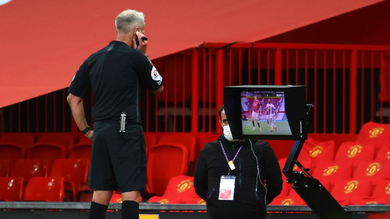 Martin Atkinson checks his monitor before awarding Palace the spot-kick