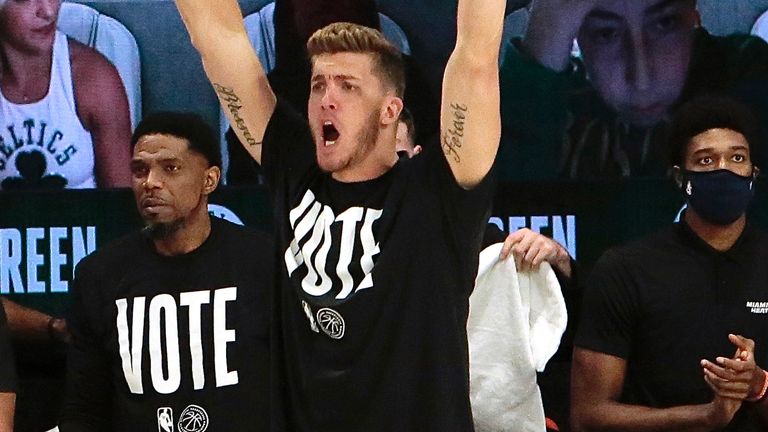 Meyers Leonard cheers on his team-mates from the Miami Heat bench