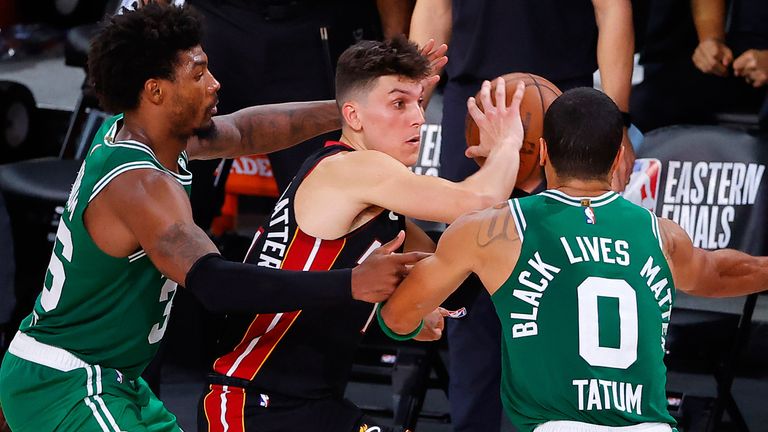 Tyler Herro is double-teamed by Marcus Smart and Jayson Tatum