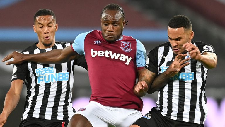 Michail Antonio of West Ham United is challenged by Isaac Hayden and Jamaal Lascelles of Newcastle