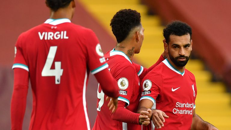 Mohamed Salah celebrates scoring his second goal with Roberto Firmino