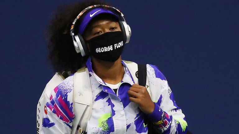 Naomi Osaka of Japan walks in wearing a mask with the name of George Floyd on it before her Women’s Singles quarter-finals match against Shelby Rogers of the United States on Day Nine of the 2020 US Open at the USTA Billie Jean King National Tennis Center on September 8, 2020 in the Queens borough of New York City.