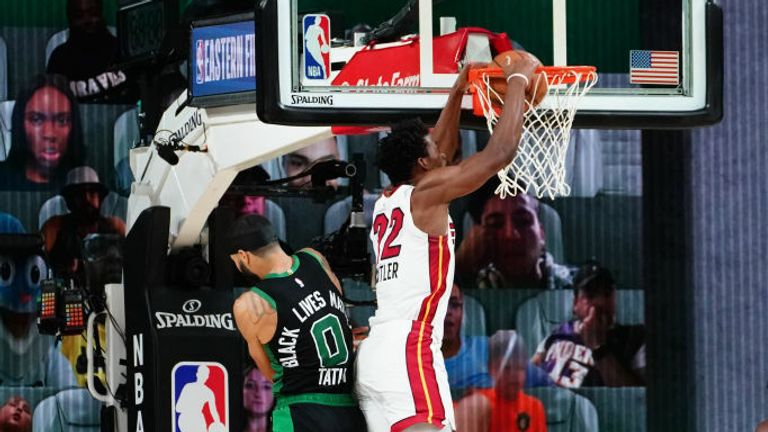 Jimmy Butler #22 of the Miami Heat dunks the ball against Jayson Tatum #0 of the Boston Celtics during Game Two of the Eastern Conference Finals of the NBA Playoffs on September 17, 2020 at the AdventHealth Arena at ESPN Wide World Of Sports Complex in Orlando, Florida.
