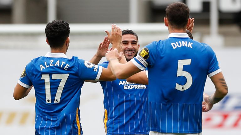 Neal Maupay celebrates his goal with Steven Alzate and Lewis Dunk