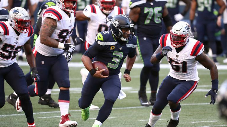Russell Wilson #3 of the Seattle Seahawks runs with the ball against Ja&#39;Whaun Bentley #51 of the New England Patriots in the first quarter at CenturyLink Field on September 20, 2020 in Seattle, Washington. 