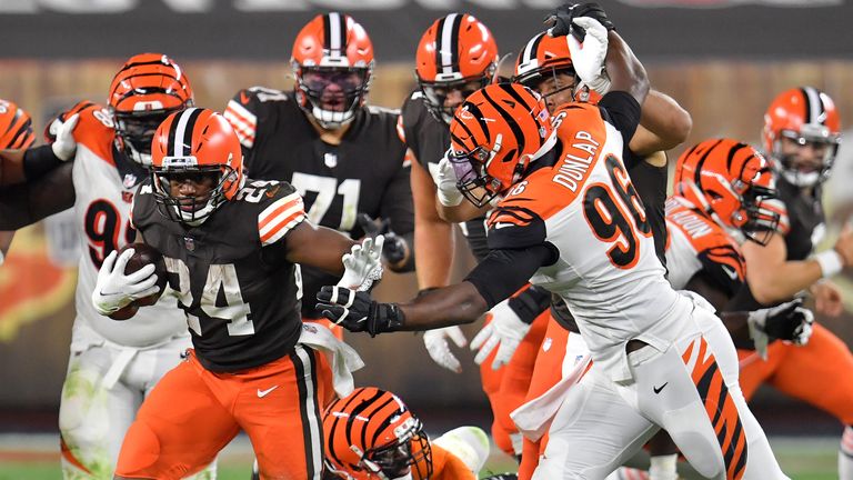 Nick Chubb of the Cleveland Browns runs against Carlos Dunlap of the Cincinnati Bengals