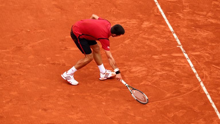 Novak Djokovic of Serbia draws a heart on the court following his victory during the Men's Singles final match against Andy Murray of Great Britain on day fifteen of the 2016 French Open at Roland Garros on June 5, 2016 in Paris, France.