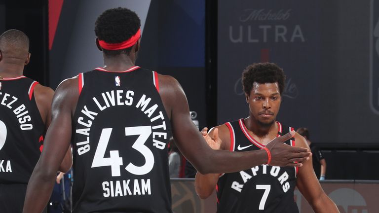 Pascal Siakam and Kyle Lowry of the Toronto Raptors hi-five during the game against the Boston Celtics during Game Four of the Eastern Conference Semi-finals