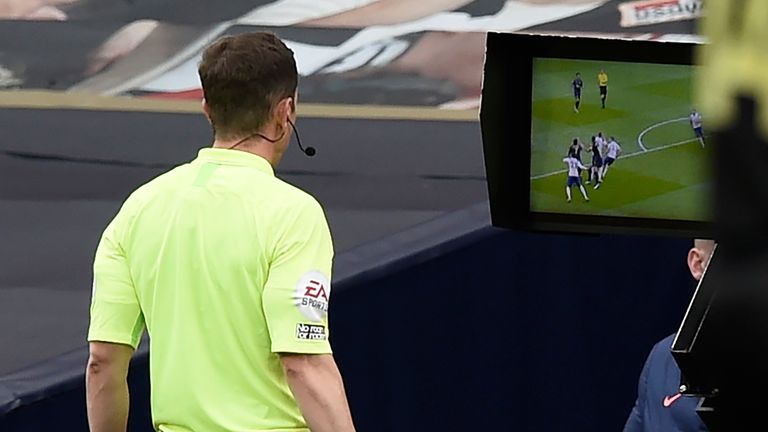 Referee Peter Bankes checks the pitchside monitor before awarding a penalty to Newcastle 