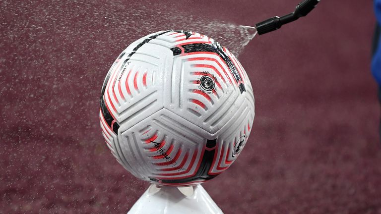 A ball is disinfected on the opening weekend of the Premier League