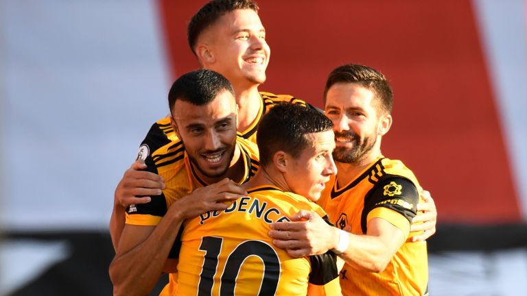 Romain Saiss is mobbed after doubling Wolves' lead