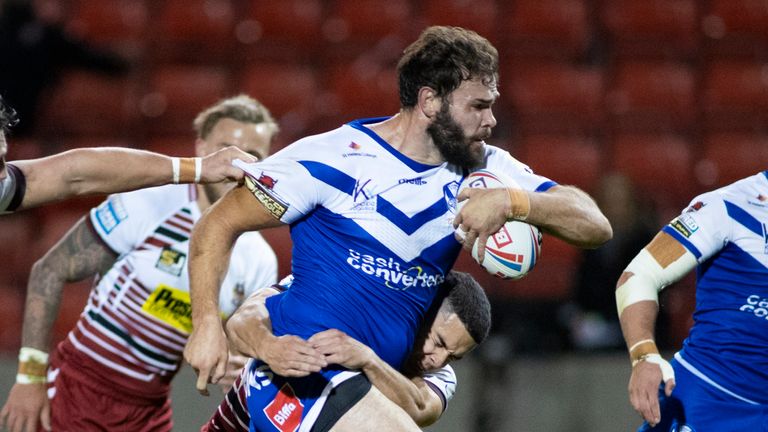 Try-scorer Alex Walmsley takes on the Wigan defence