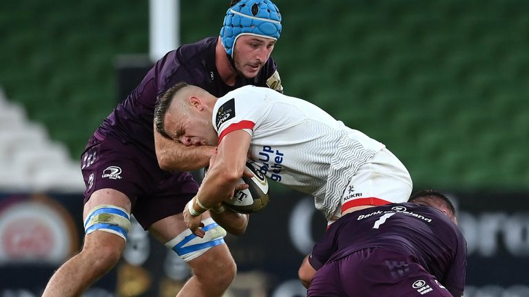 Ian Madigan of Ulster is tackled by Will Connors and Ed Byrne of Leinster