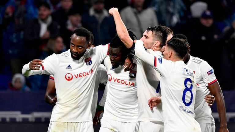 Traore is mobbed by his Lyon teammates after scoring in the Champions League against Benfica last season