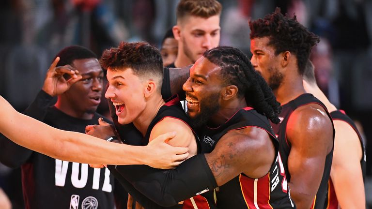 Jae Crowder and Tyler Herro of the Miami Heat smile and celebrate on the court after Game Four of the Eastern Conference Finals against the Boston Celtics