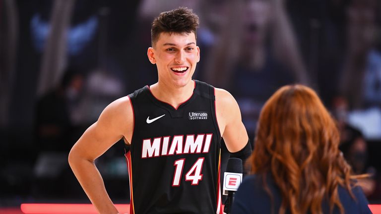 Tyler Herro of the Miami Heat smiles and talks the media on the court after Game Four of the Eastern Conference Finals against the Boston Celtics