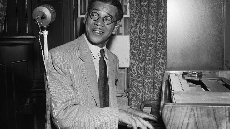 24th August 1954: Ex-Olympic sprinter, Jack London, playing the piano. London was silver medallist in the 100 metres event at the Amsterdam Olympics in 1928