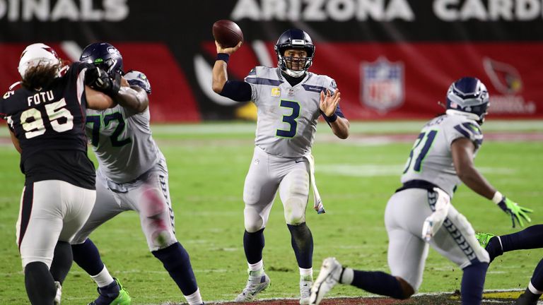Seattle Seahawks quarterback Russell Wilson throws a goal line interception to Arizona Cardinals safety Budda Baker who returns it 90 yards before being tackled by wide receiver D.K. Metcalf.
