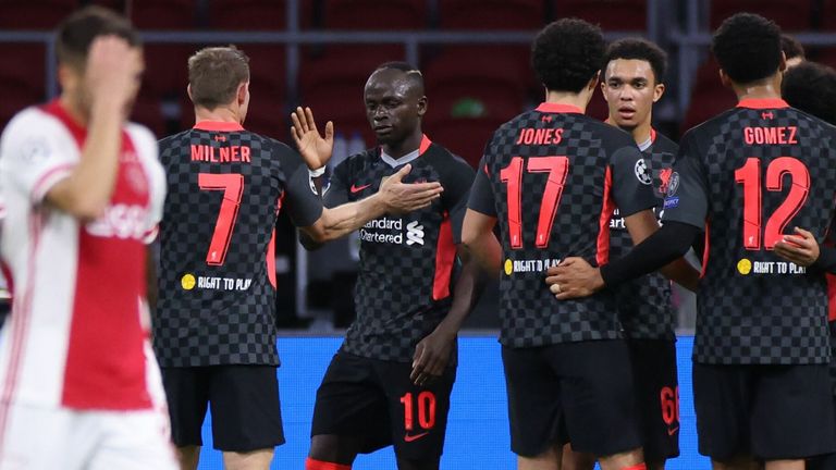 Liverpool players celebrate taking the lead at Ajax through Nicolás Tagliafico's own goal