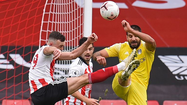 Aleksandar Mitrovic (R) fouls Sheffield United's English defender Jack Robinson (L) for a penalty 