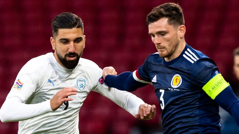 Scotland's Andrew Robertson and Munas Dabbur in action 