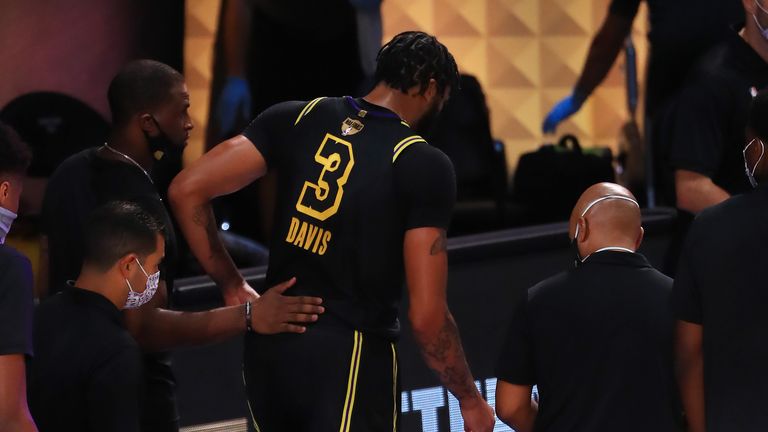 Anthony Davis of the Los Angeles Lakers is helped off the court during the first quarter against the Miami Heat in Game Five of the 2020 NBA Finals