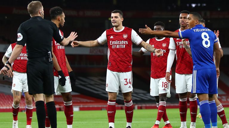 Arsenal and Leicester players protest as the Gunners' early goal is ruled out for offside