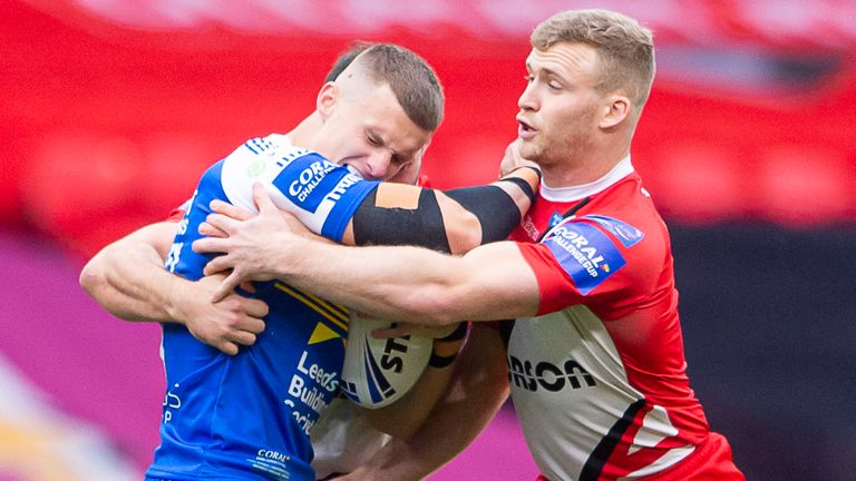Leeds try-scorer Ash Handley is tackled by Salford's Joey Lussick