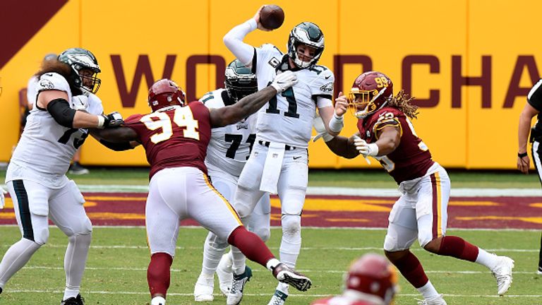 LANDOVER, MD - SEPTEMBER 13:  Daron Payne #94 and Chase Young #99 of the Washington Football Team tackle Carson Wentz #11 of the Philadelphia Eagles in the second half at FedExField on September 13, 2020 in Landover, Maryland.  (Photo by Greg Fiume/Getty Images)