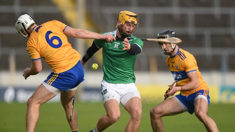 Tom Morrissey of Limerick in action against Patrick O'Connor and Stephen O'Halloran of Clare