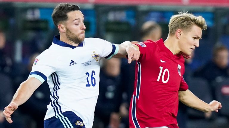Northern Ireland's forward Conor Washington (L) and Norway's midfielder Martin Odegaard vie for the ball