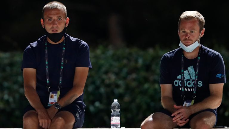 Dan Evans of Britain (L) and his coach Mark Hilton of Britain watch the match between Kyle Edmund of Britain and Marco Cecchinato of Italy on day two of the Italian Open at Foro Italico on September 15, 2020 in Rome, Italy.