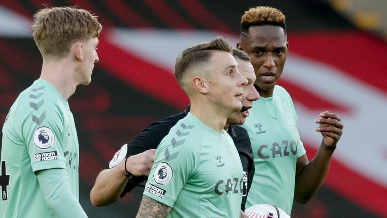 Referee Kevin Friend gives Lucas Digne of Everton a helping hand and a straight red after his tackle on Kyle Walker-Peters of Southampton during the Premier League match between Southampton and Everton at St Mary&#39;s Stadium on October 25, 2020 in Southampton, England.