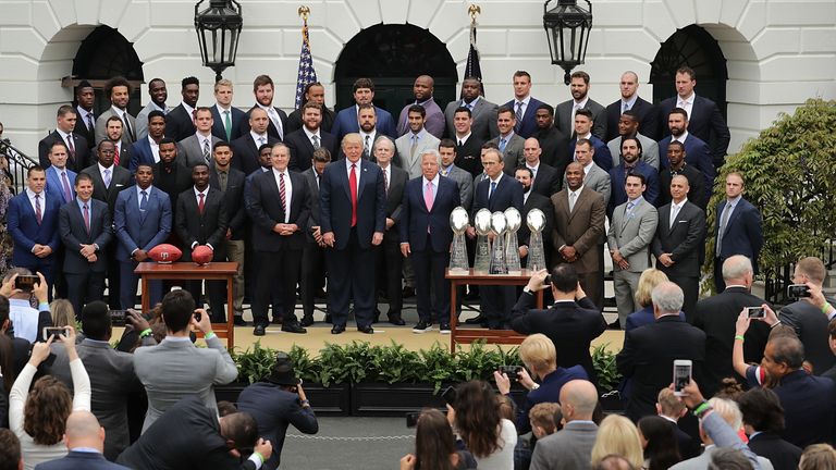 Trump poses for photographs with the New England Patriots during a celebration of the team's Super Bowl victory in 2017
