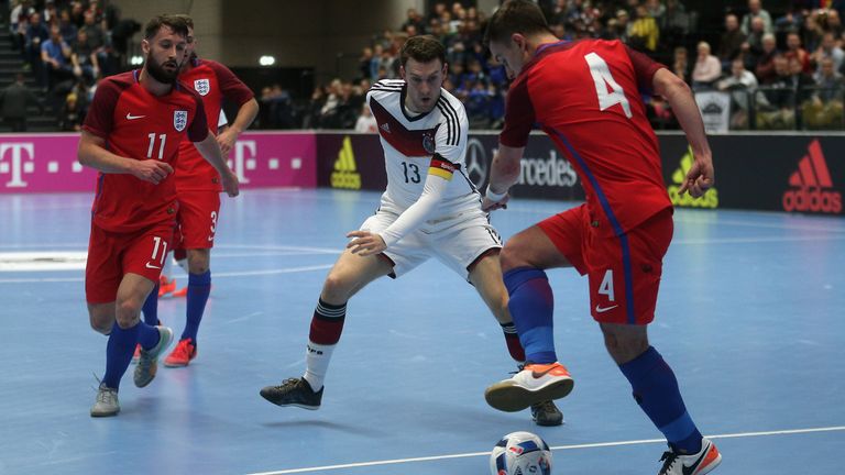 Nils Klems (C) of Germany and Douglas Reed of England compete for the ball during the Futsal International Friendly match between Germany and England at Inselparkhalle on November 1, 2016 in Hamburg, Germany