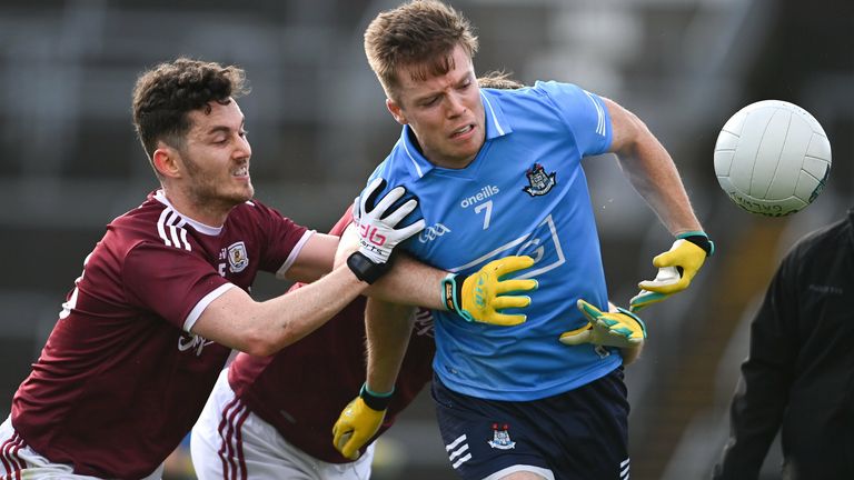 Robert McDaid of Dublin is tackled by Ian Burke and Tom Flynn of Galway