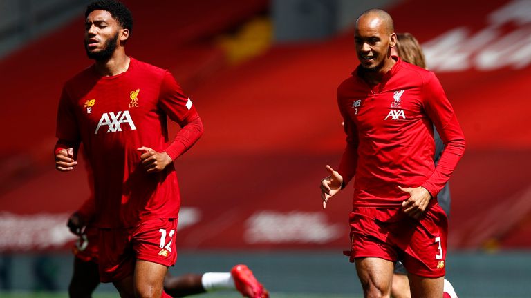 Joe Gomez and Fabinho of Liverpool warm up prior to the Premier League match between Liverpool FC and Burnley FC at Anfield on July 11, 2020 in Liverpool, England. Football Stadiums around Europe remain empty due to the Coronavirus Pandemic as Government social distancing laws prohibit fans inside venues resulting in all fixtures being played behind closed doors. (Photo by Clive Brunskill/Getty Images)