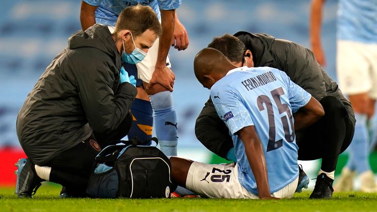 Fernandinho is treated by City's medical staff after going down injured in stoppage-time against Porto