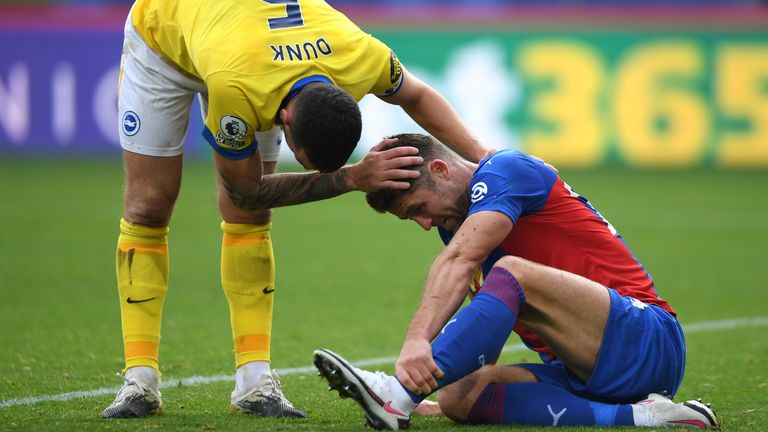 Lewis Dunk checks on Gary Cahill after being sent off for a dangerous tackle 