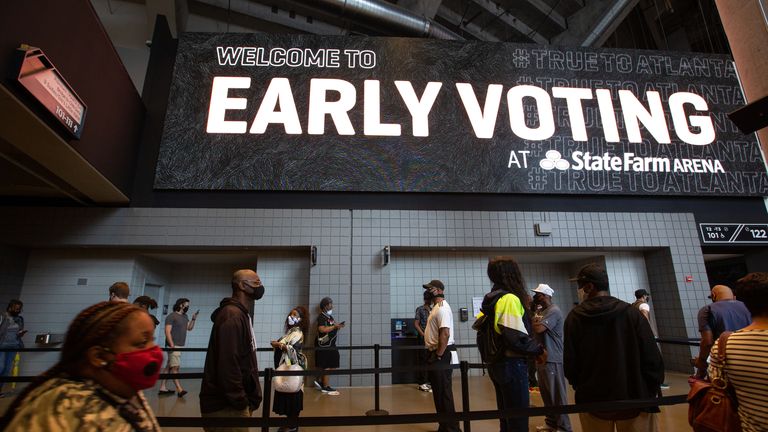 ATLANTA, GA - OCTOBER 12: Voters line up inside of State Farm Arena, Georgia's largest early voting location, for the first day of early voting in the General Election on October 12, 2020 in Atlanta, Georgia. Early voting in Georgia runs October 12-30.  (Photo by Jessica McGowan/Getty Images)