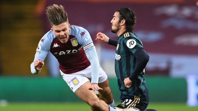 Jack Grealish of Aston Villa is tackled by Pascal Struijk of Leeds United