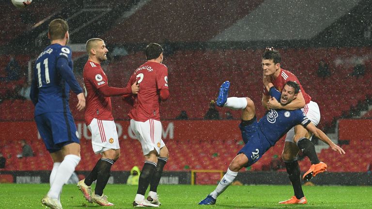 Harry Maguire climbs over Cesar Azpilicueta to head clear