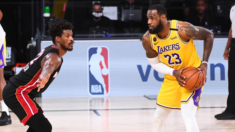 LeBron James of the Los Angeles Lakers handles the ball against Jimmy Butler of the Miami Heat during Game Four of the NBA Finals