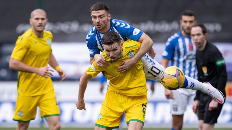 Hibernian's Paul McGinn (R) holds off Kilmarnock's Greg Kiltie