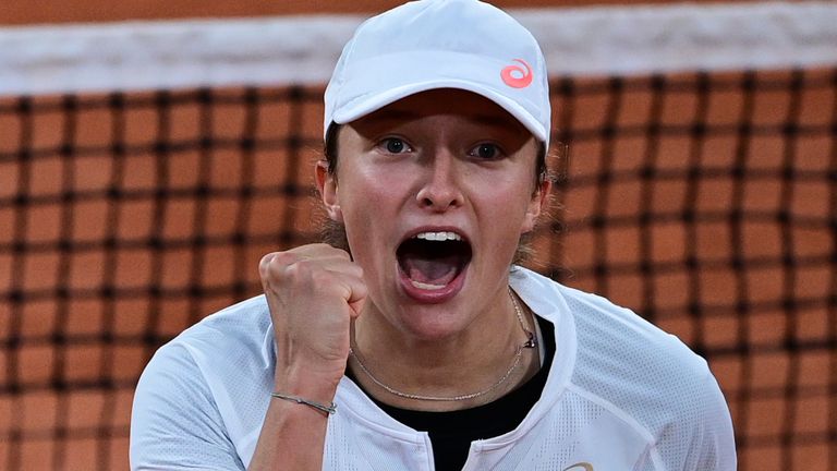 Poland's Iga Swiatek celebrates after winning against Romania's Simona Halep during their women's singles fourth round tennis match on Day 8 of The Roland Garros 2020 French Open tennis tournament in Paris on October 4, 2020.